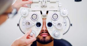 Person comparing rectangular and round eyeglass frames in front of a mirror.